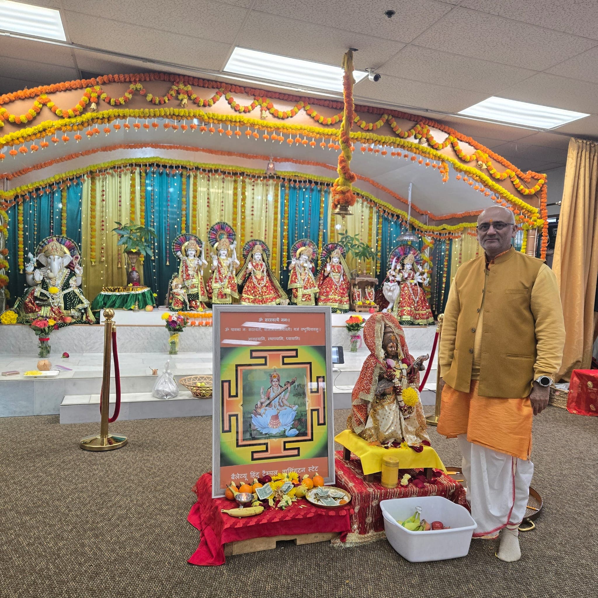 Person seated with religious items and decorations